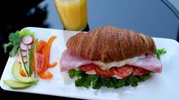 Croissant with jamon ham, Salmon, in Modern Cafe, Top View of Healthy Breakfast in Cafe. English breakfast. fried egg, bacon toast on sandwich. video