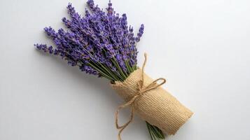 Purple Lavender Bouquet Wrapped in Burlap on Gray Background photo