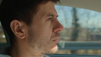 Man driving car, looking ahead with focus and concentration. Close up portrait of male driver in vehicle video