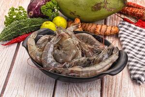 A bowl of shrimp and vegetables on a table photo