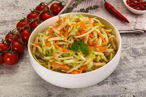 A bowl of salad with carrots and tomatoes photo