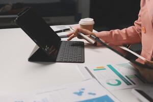 A person is using a tablet computer at a desk photo