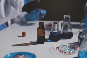 A person in a lab coat is holding a bottle photo