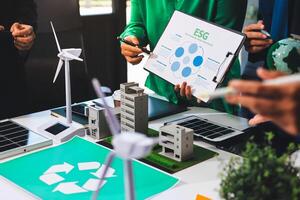 People are looking at a paper with a recycling symbol on it photo