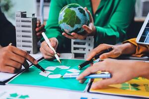 People working on a project with a green earth photo