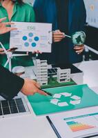 Business people working on a presentation with a recycling symbol photo