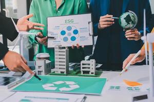 People working on a table with a recycling symbol photo