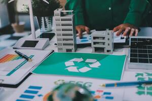 A woman working on a project with a recycling symbol on it photo