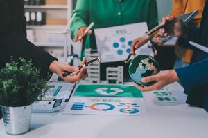 Business people working together on a table with a globe and other items photo