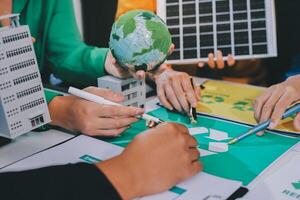 People working on a project with a green globe photo