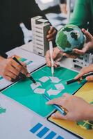 People working on a project with a green globe photo