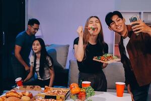 A group of people enjoying pizza and drinks photo