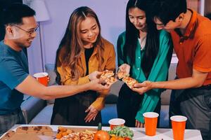 A group of people holding pizza and drinks photo
