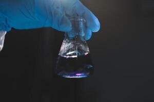 A person holding a flask with a liquid in it photo