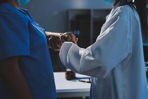 Two doctors shaking hands in a hospital photo