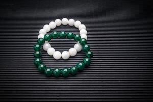 Close-up of two Jade bangles or bracelets on a black background photo