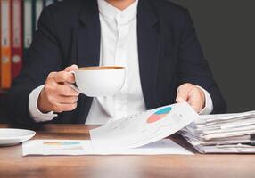 Hand holding of form 1040 U.S. individual income tax return while sitting at the table in the office photo