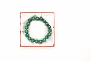 Top view of Jade bangle or bracelet in a red box on a white background photo