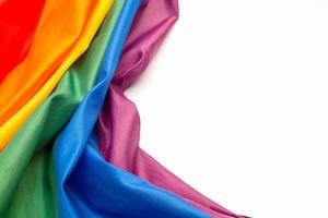 The rainbow flag or LGBTQ flag is isolated on a white background. Top view. photo