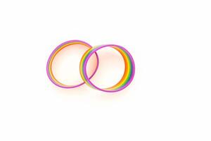 Top view of a rainbow patterned wristbands are on a white background. photo