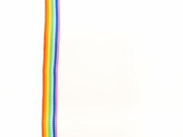 Close-up of a rainbow cloth ribbon on a white background. Top view. photo