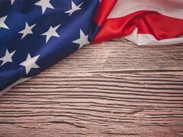 Part of the American flag is on a wooden table with copy space for text photo