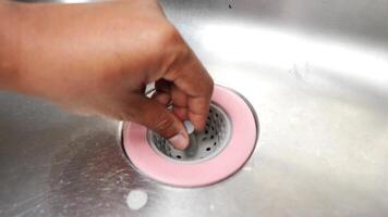 Cleaning a kitchen sink drain to prevent clogs and odor buildup video