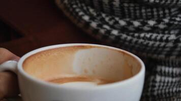 Enjoying a warm cup of coffee in a cozy cafe setting video