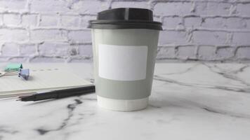 Coffee cup placed on marble table in a minimal workspace setup video
