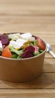 Fresh salad bowl with assorted vegetables and toppings in a cafe video
