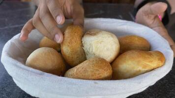 Freshly baked bread rolls served in a basket on a table video