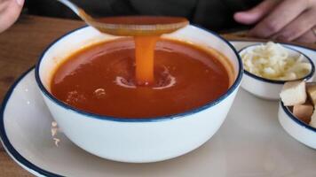Delicious soup served in a bowl with side accompaniments video