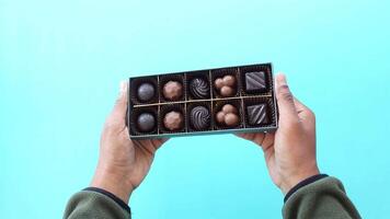 Enjoying assorted handmade chocolates in vibrant setting video
