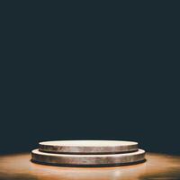 A 3D stone podium with two levels on a textured surface, set against a dark background. photo