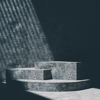 3D A multi-tiered, concrete platform is shown against a matching wall. Harsh, striped sunlight creates dramatic shadows. The scene has a minimalist and industrial aesthetic. photo