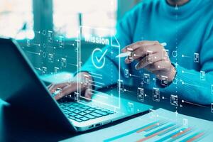 Business people working on laptop with virtual screen.Online documentation database, IT consultant being set up Virtual Document Management System with laptop.Software for archiving corporate files. photo