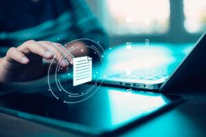 Businesswoman working on laptop with virtual screen.Online documentation database, IT consultant being set up Virtual Document Management System with a laptop, Software for archiving corporate files. photo