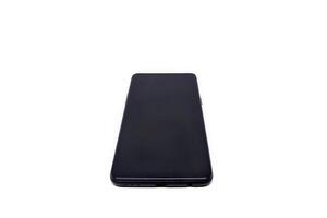A black smartphone on a white surface photo