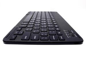 A black wireless keyboard on a white background photo
