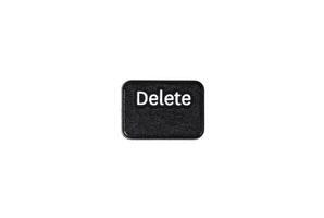 Black delete button closeup on white background photo