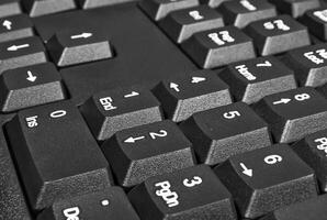 Black keyboard with numbers and arrows on the buttons photo