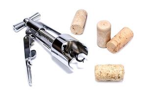 Corkscrew and wine corks isolated on white background photo