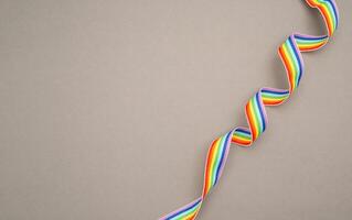 Top view of a rainbow cloth ribbon on a gray background. photo