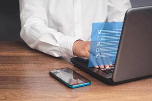 Checklist, task management, and filling out survey forms online on a virtual screen photo