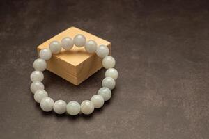 White jade bangles on a wooden cubes over a table photo