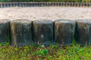 Circular stone perimeter surrounding a sandy area in a natural setting during daylight photo