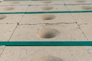 Construction materials showcase the unique texture and design of concrete blocks with circular indentations photo