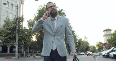 A Stylish Man on a Phone Call in an Urban Setting, Exuding Confidence and Professionalism video