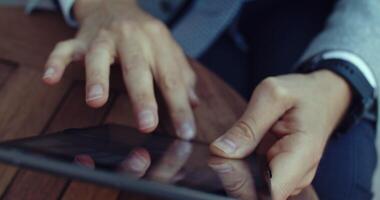A Business Professional Engaged in Using a Tablet for Work and Related Tasks Effectively video