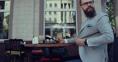 Sophisticated Gentleman Enjoying a Drink at Outdoor Caf video